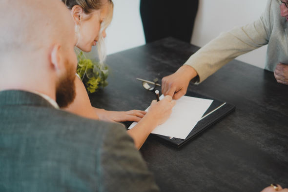 Couple signing marriage paperwork NOIM Melbourne 